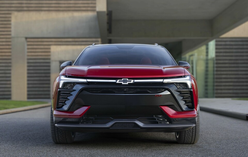 Front view of 2024 Chevrolet Blazer EV SS in Radiant Red Metallic with headlights illuminated. Preproduction model shown. Actual production model may vary. 2024 Chevrolet Blazer EV available Spring 2023.