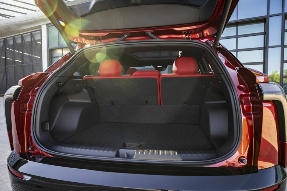 Rear view of 2024 Chevrolet Blazer EV SS in Radiant Red Tintcoat through open trunk. Preproduction model shown. Actual production model may vary. 2024 Chevrolet Blazer EV available Spring 2023.