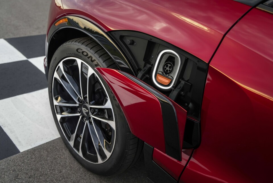 Close up of wheel and illuminated charge port on 2024 Chevrolet Blazer EV SS in Radiant Red Tintcoat. Preproduction model shown. Actual production model may vary. 2024 Chevrolet Blazer EV available Spring 2023.